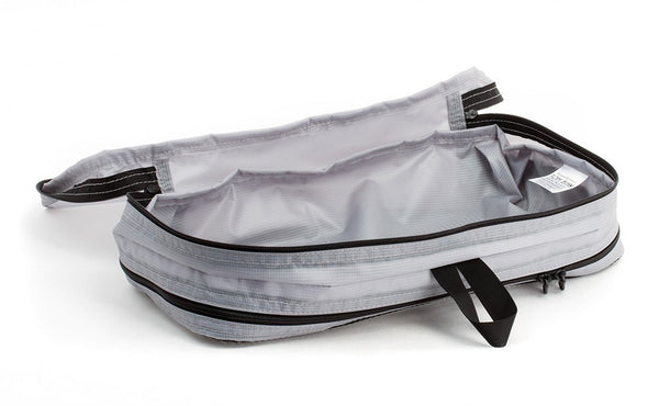 An empty and open Northwest Sky (light grey) Aether Small Aeronaut 45 Packing Cube open all-fabric side up.